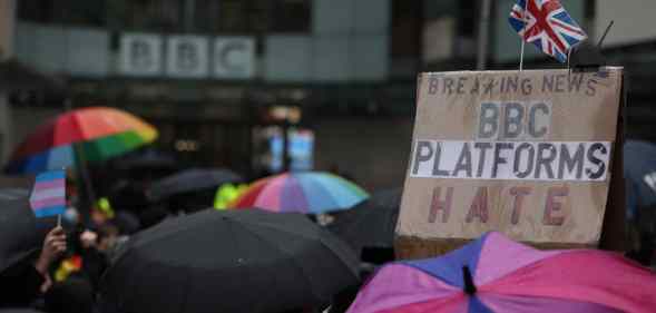Demonstrators holding signs attend the Trans Activism UK's 'British Bigotry Corporation: Platforming Hate Is Not Impartial' protest at BBC Broadcasting House