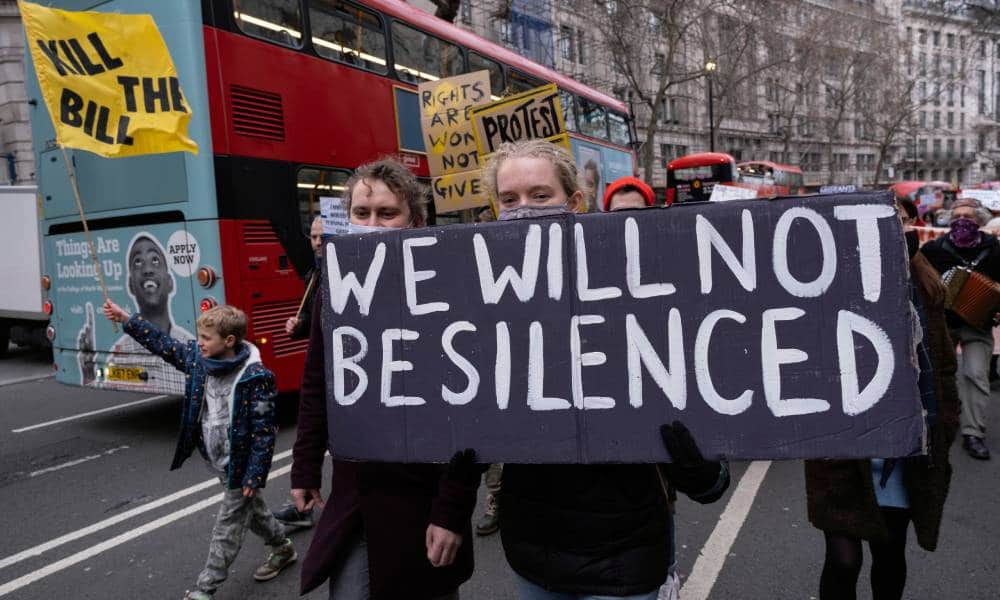 Protestors hold up a sign reading 'we will not be silenced' at demonstration against the Conservative plans for the new Policing Bill in the UK