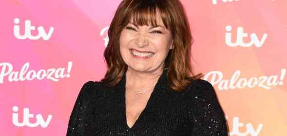Lorraine Kelly smiles at the camera while wearing a black sparkly outfit
