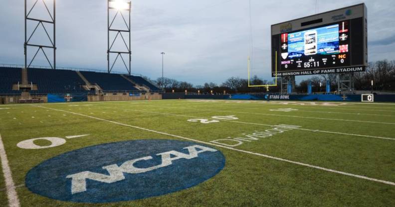An empty playing field with the NCAA logo on it
