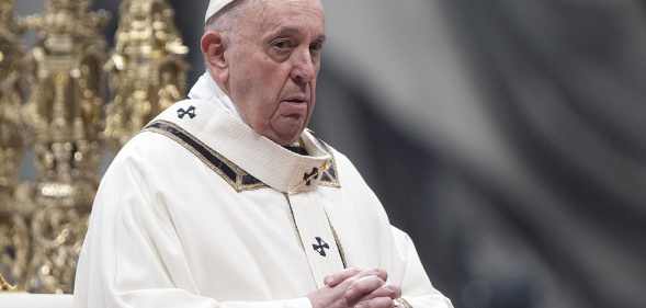 Pope Francis claps his hands at a mass