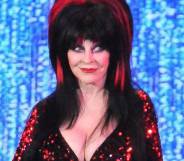 Elvira, played by Cassandra Peterson, appears at the Elvira's Sinema Seance in a black and red outfit
