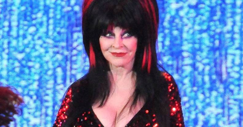 Elvira, played by Cassandra Peterson, appears at the Elvira's Sinema Seance in a black and red outfit