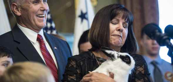 Former vice president Mike Pence and his wife Karen Pence look over their pet rabbit, Marlon Bundo
