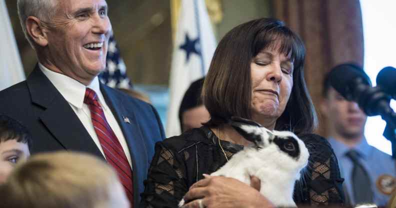 Former vice president Mike Pence and his wife Karen Pence look over their pet rabbit, Marlon Bundo