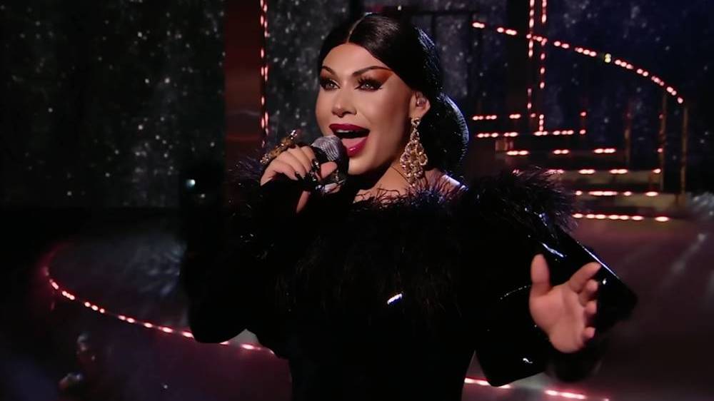 Grag Queen performs in a black dress on Queen of the Universe
