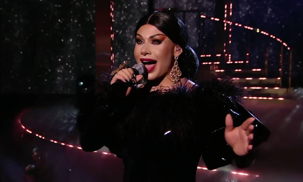Grag Queen performs in a black dress on Queen of the Universe