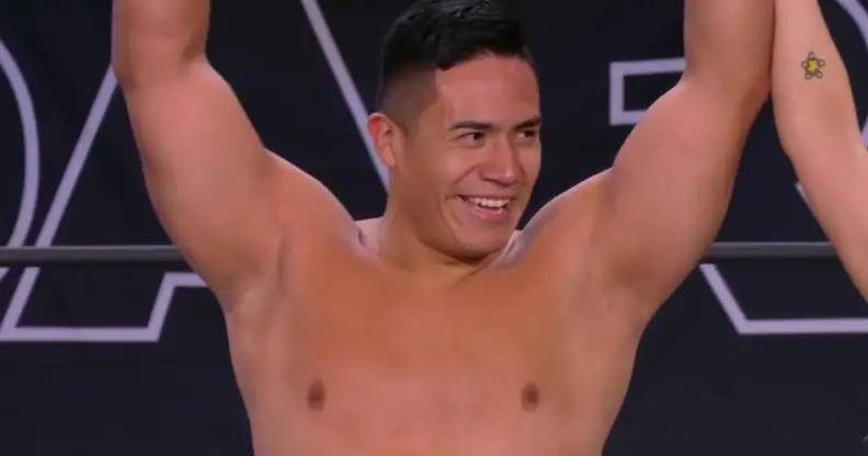 Jake Atlas holds up his arms in triumph after winning his debut match with All Elite Wrestling