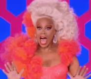 RuPaul smile and waves hands