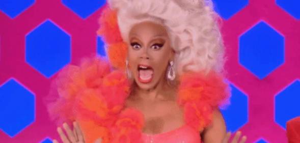 RuPaul smile and waves hands