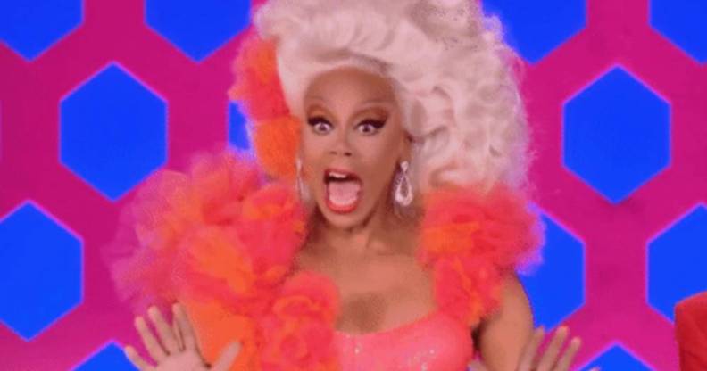 RuPaul smile and waves hands