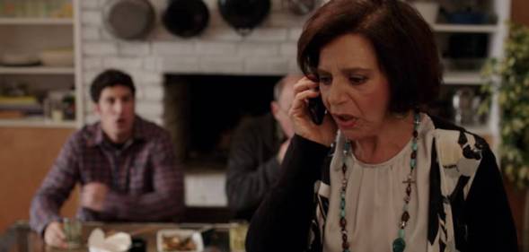 Kathryn Kates, playing Amy Kanter-Bloom, speaks into a phone