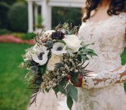 Bride holding flowers and wearing a wedding dress