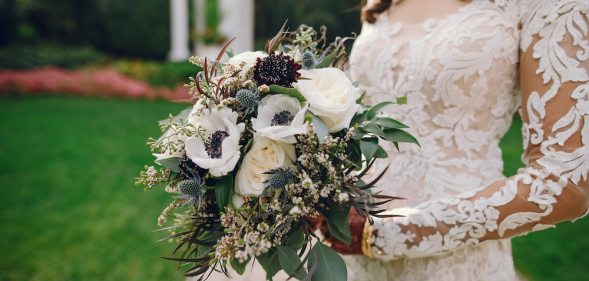 Bride holding flowers and wearing a wedding dress