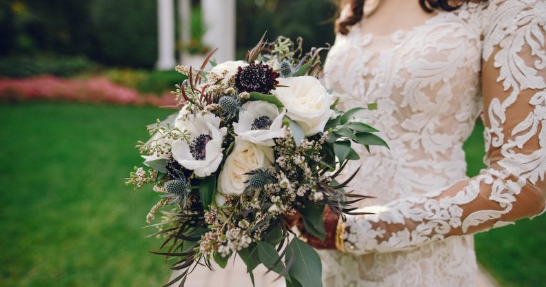 Bride holding flowers and wearing a wedding dress