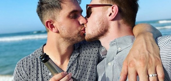 Max Parker and Kris Mochrie share a kiss on the beach