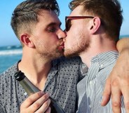 Max Parker and Kris Mochrie share a kiss on the beach