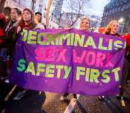Sex workers and allies hold a banner reading: Decriminalise sex work, safety first