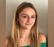 Gemma Tutton smiles at the camera while wearing a green top