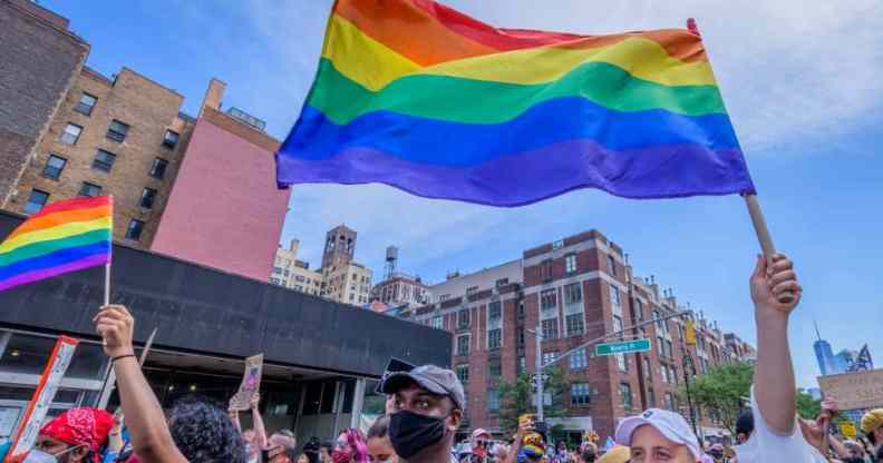 Participants hold LGBT+ rainbow flags during the second annual Queer Liberation March