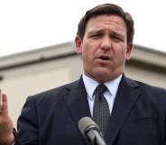 Ron DeSantis wears a suit and tie during a press conference