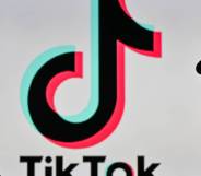 An image of a woman holding a cell phone in front of a TikTok logo displayed on a computer screen