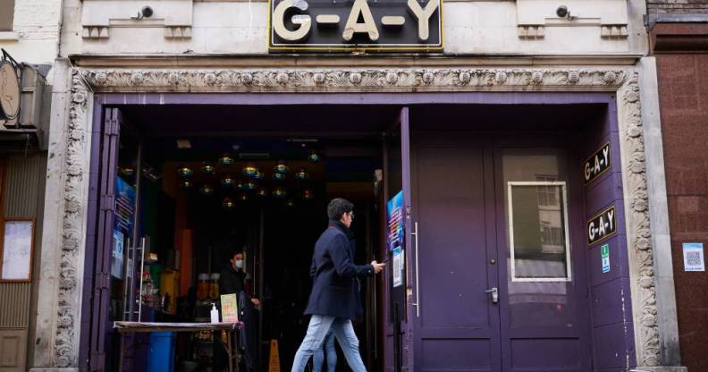 A person walks past the G-A-Y bar and venue in London, England