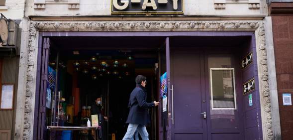 A person walks past the G-A-Y gay bar venue in London, England.