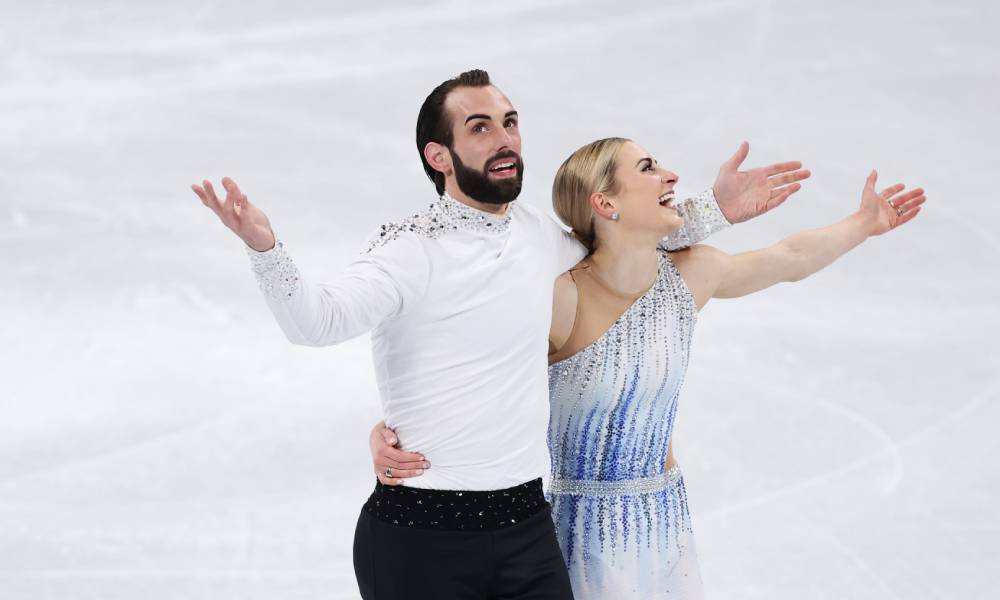 Team USA's Timothy LeDuc and Ashley Cain-Gribble react after skating during the Pair Skating Short Program at the 2022 Beijing Olympics