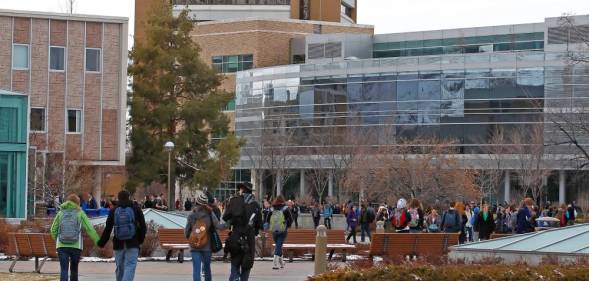Groups of students walk across the campus of Brigham Young University BYU