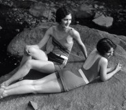 Two women relaxing on a rock in the 1920s