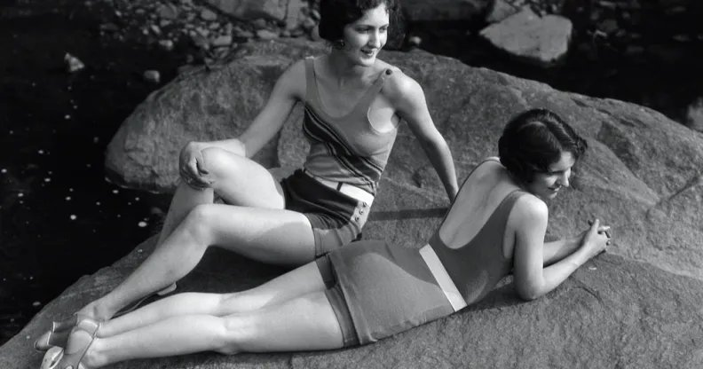 Two women relaxing on a rock in the 1920s