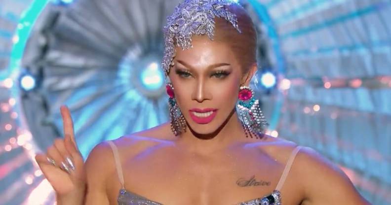 Pangina Heals, an Asian drag queen, wears a glittery silver hair piece and matching top