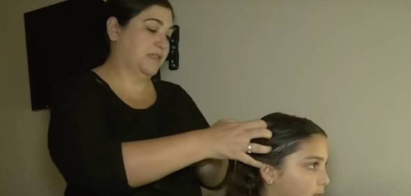 Lisa Stanton, a mother in Texas, is doing the hair of her daughter Maya