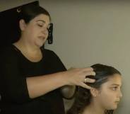Lisa Stanton, a mother in Texas, is doing the hair of her daughter Maya
