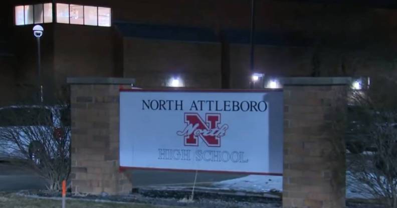 A sign for North Attleboro High School as seen at night