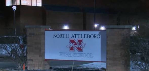 A sign for North Attleboro High School as seen at night