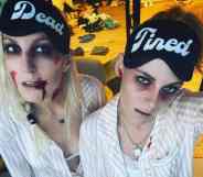 Dylan Meyer and Kristen Stewart dress up as zombies with pale complexions and fake blood while wearing eye masks that read 'dead tired'