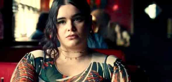 Euphoria character Kat, played by Barbie Ferreira, sits at a restaurant table