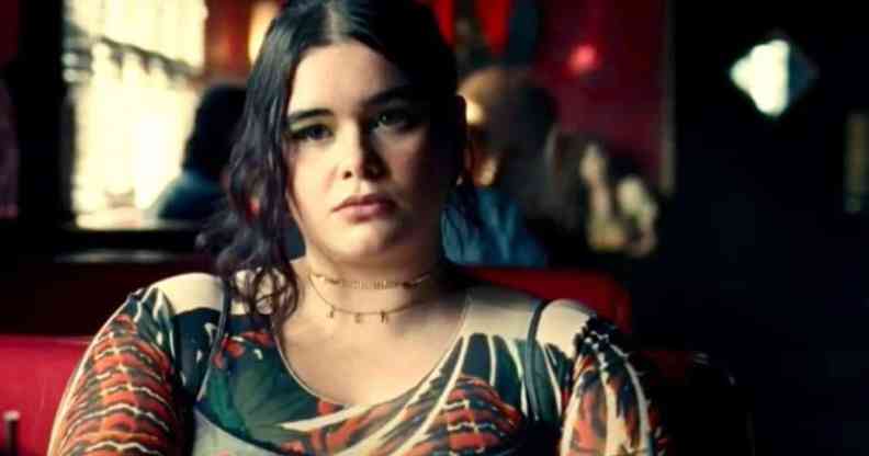 Euphoria character Kat, played by Barbie Ferreira, sits at a restaurant table
