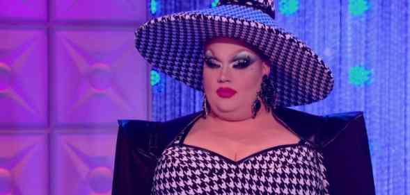 Eureka, a competitor on drag competition RuPaul's Drag Race, wears a black and white patterned outfit and hat