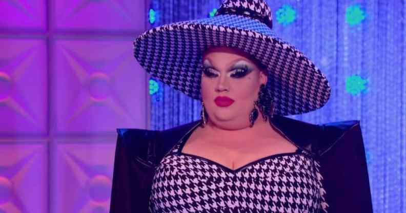 Eureka, a competitor on drag competition RuPaul's Drag Race, wears a black and white patterned outfit and hat