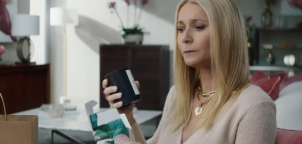 Gwyneth Paltrow looking intensely at a black candle