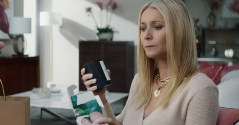 Gwyneth Paltrow looking intensely at a black candle