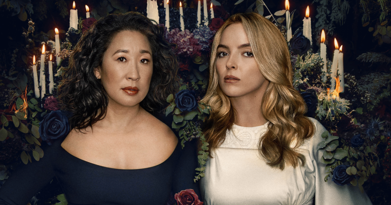 Eve and Villanelle in front of an array of candles