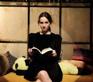 Lexi sat on a play set, holding a book