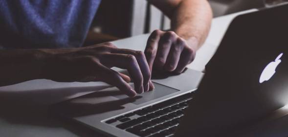 A white person is on a computer watching something on the screen