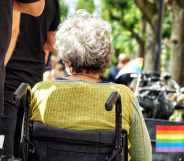 Stock photo of a person in a wheelchair at a Pride parade