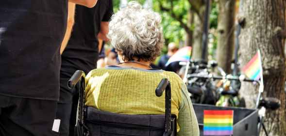 Stock photo of a person in a wheelchair at a Pride parade