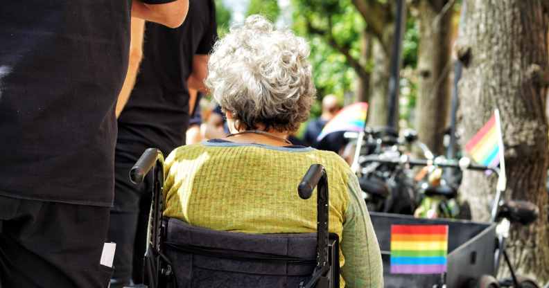 Stock photo of a person in a wheelchair at a Pride parade